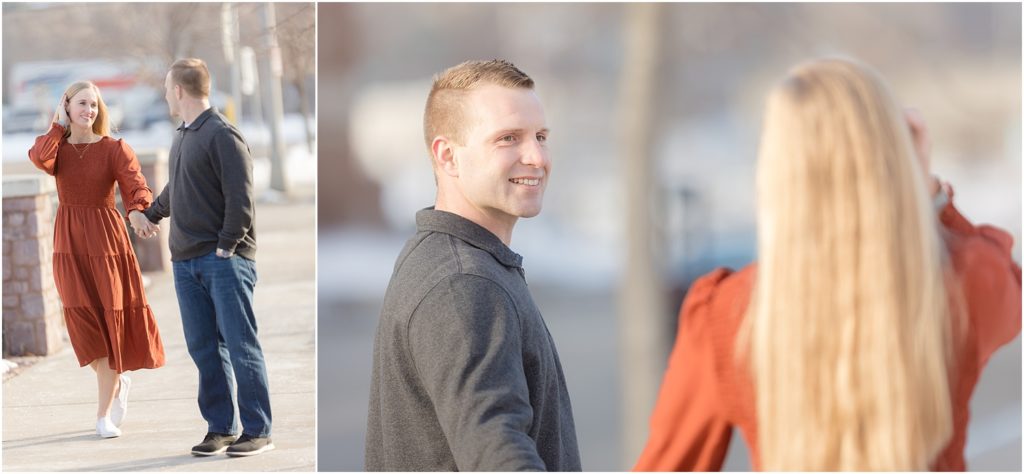 Engaged couple walking Downtown Sioux Falls during winter at sunset