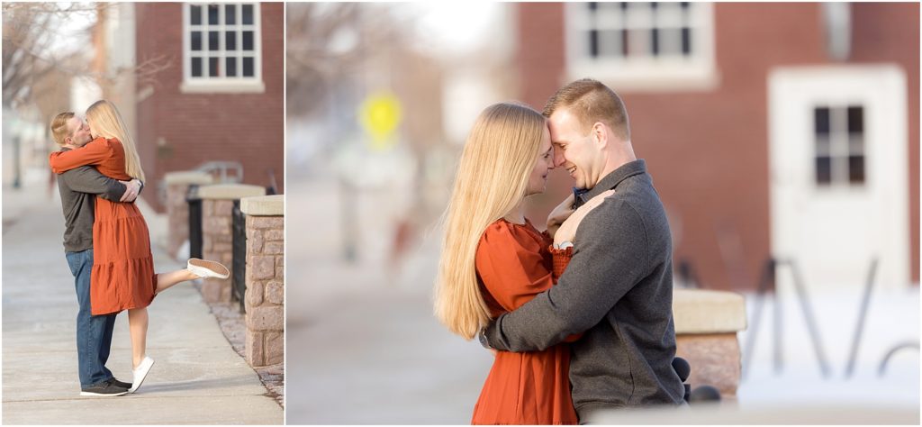 Engaged couple walking Downtown Sioux Falls during winter during sunset