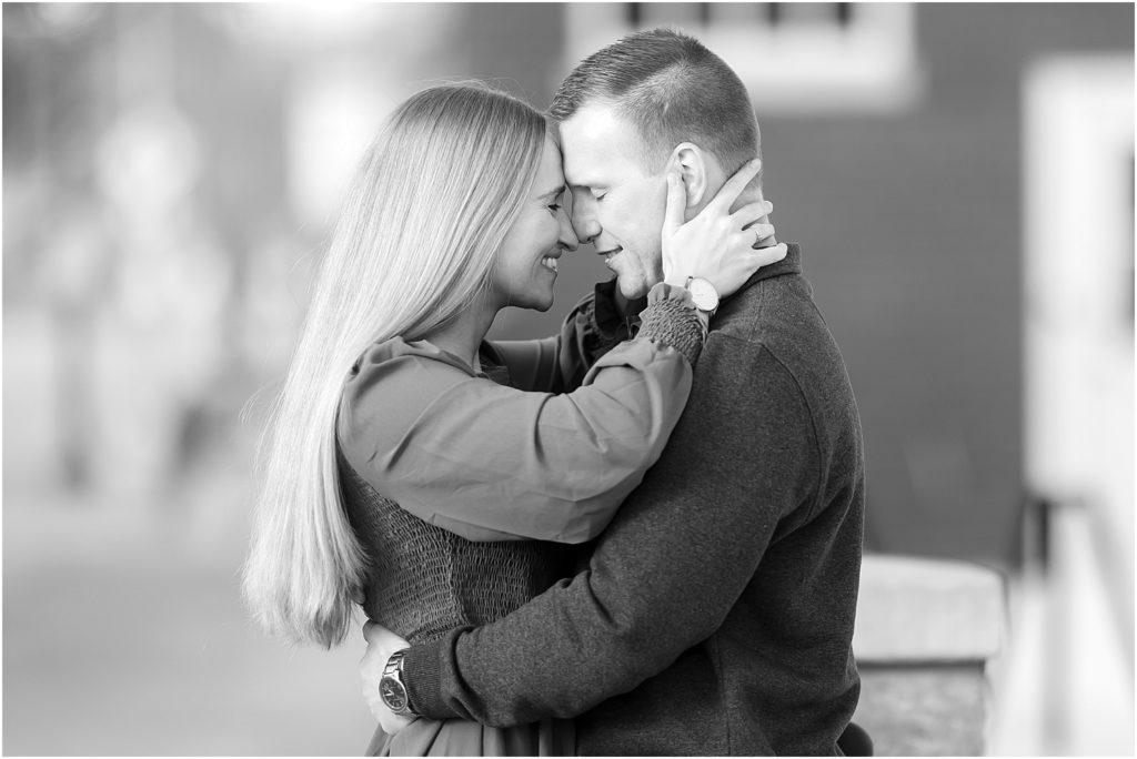 Engaged couple walking Downtown Sioux Falls during winter in black and white