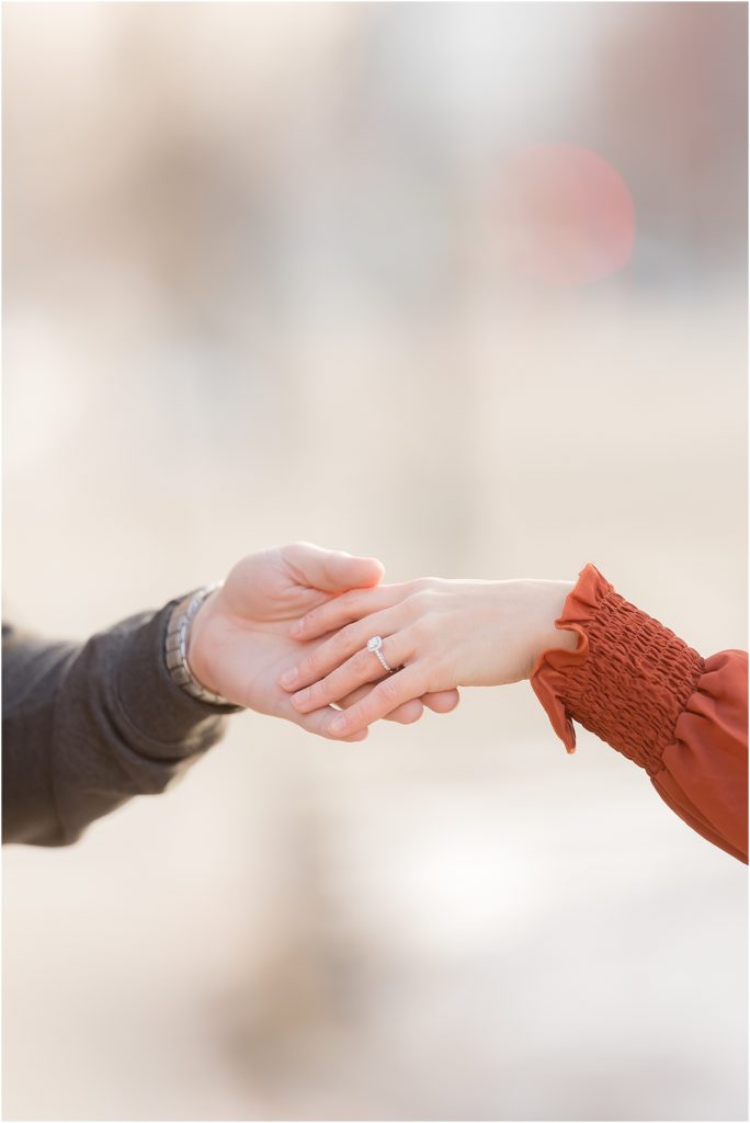 hands of Engaged couple at Downtown Sioux Falls during winter