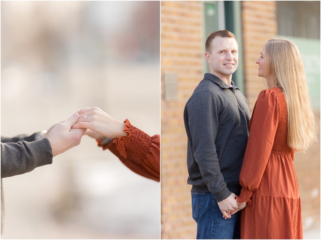 Engaged couple walking Downtown Sioux Falls during winter kissing