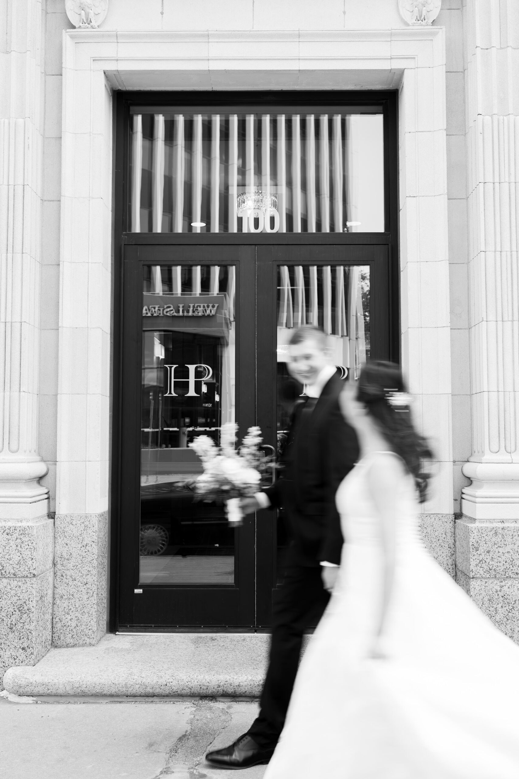 Bride and groom during their wedding day next to Hotel Phillips in Sioux Falls, South Dakota